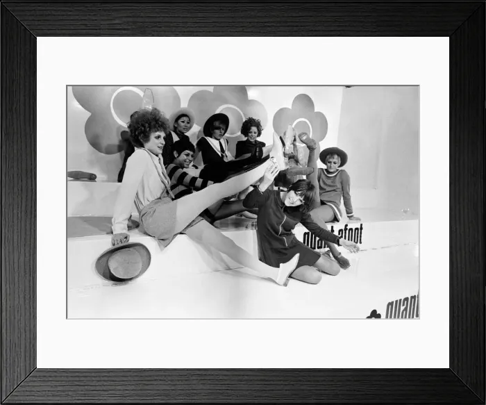 Framed Print : Mary Quant pictured in black, sitting down at the front Framed Print : Mary Quant pictured in black, sitting down at the front