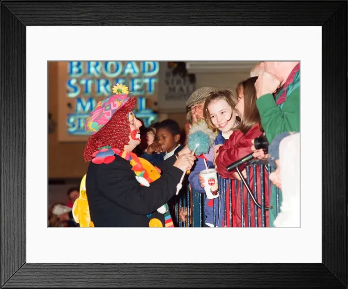 Framed Print : Christmas light switch on at Broad Street Mall, Reading. A clown entertains the crowds