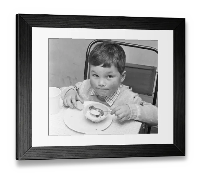 Framed Print : A small boy enjoying his jelly and ice cream during the Birch Copse School Christmas