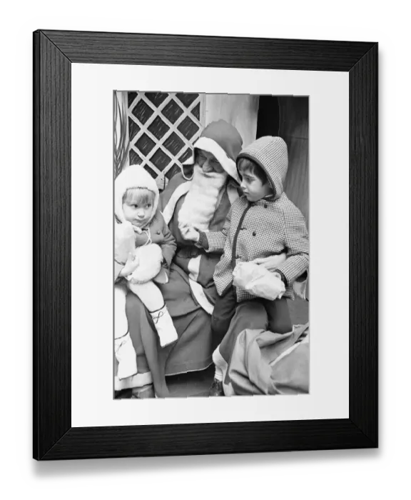 Framed Print : As her brother checks out Santa Clauss beard in Wellsteed department store in Broad Framed Print : As her brother checks out Santa Clauss beard in Wellsteed department store in Broad