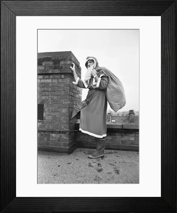 Framed Print : Father Christmas seen here on the roof of Wellsteed department store in Broad Street