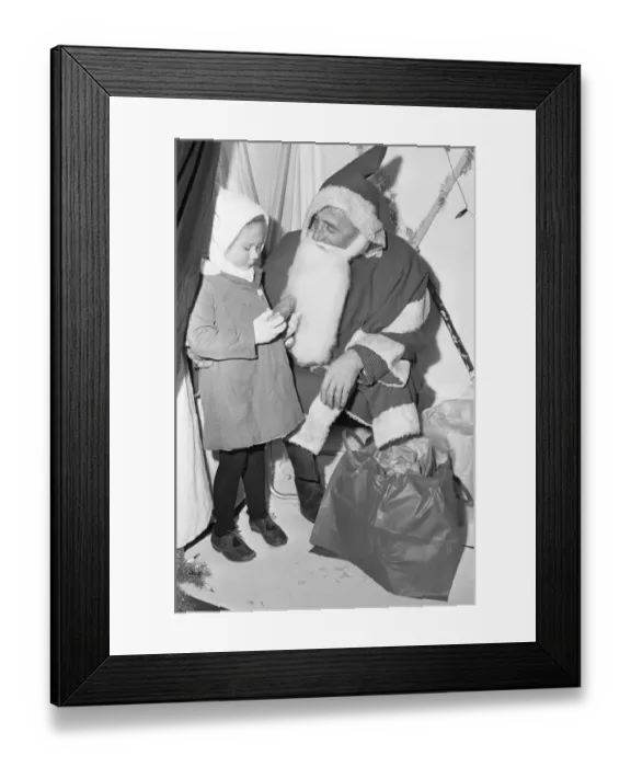Framed Print : A small girl receives a present from Father Christmas at Woodley 18th November 1966