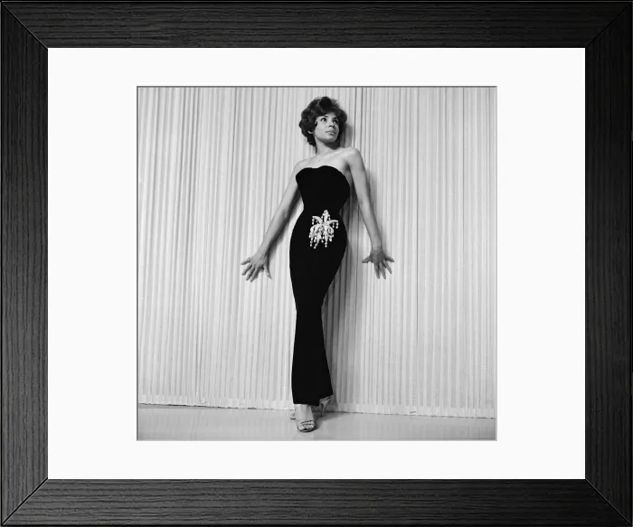 Framed Print : Shirley Bassey wearing the hip-hugging black velvet dress that she says catches mens