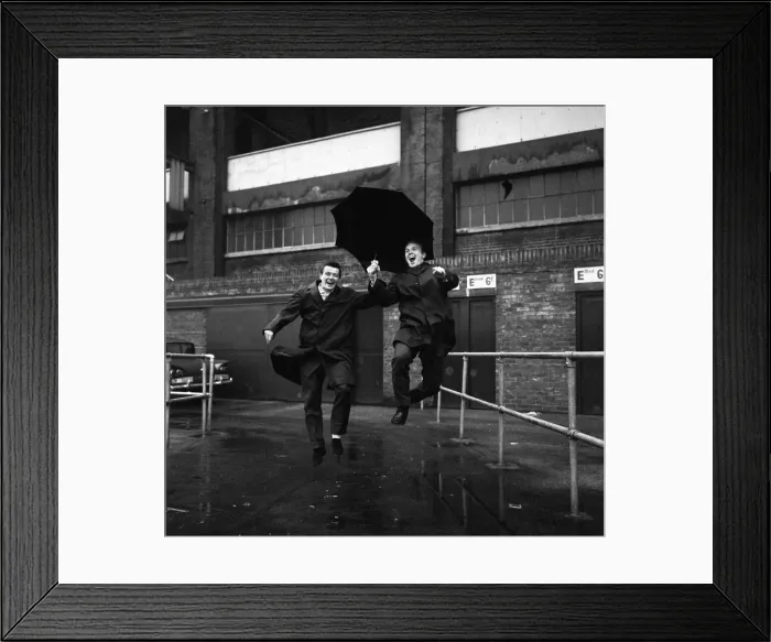 Framed Print : Johnny Byrne and Bobby Moore December 1963 of West Ham United pictured jumping a puddle
