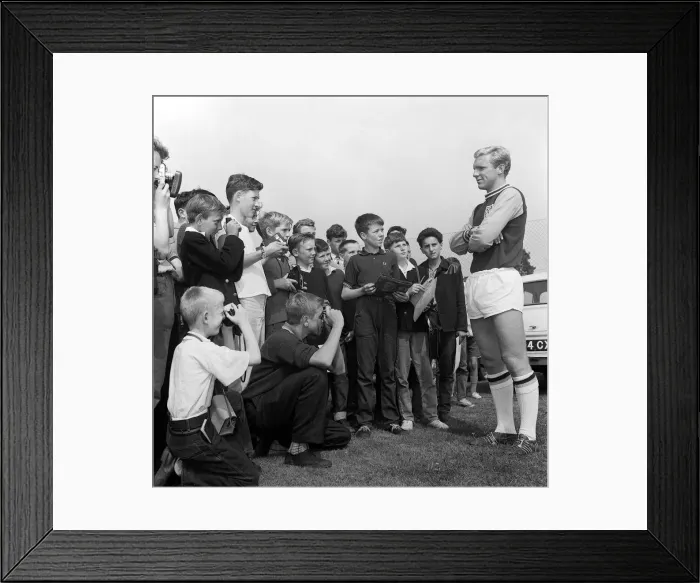 Framed Print : England player Bobby Moore August 1962 poses for young fans during West ham United Framed Print : England player Bobby Moore August 1962 poses for young fans during West ham United