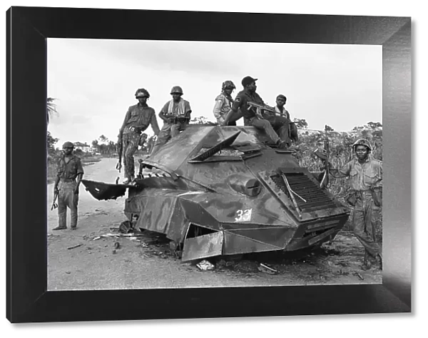 A Biafran soldiers seen here sitting on a destroyed Nigerian army armoured personnel