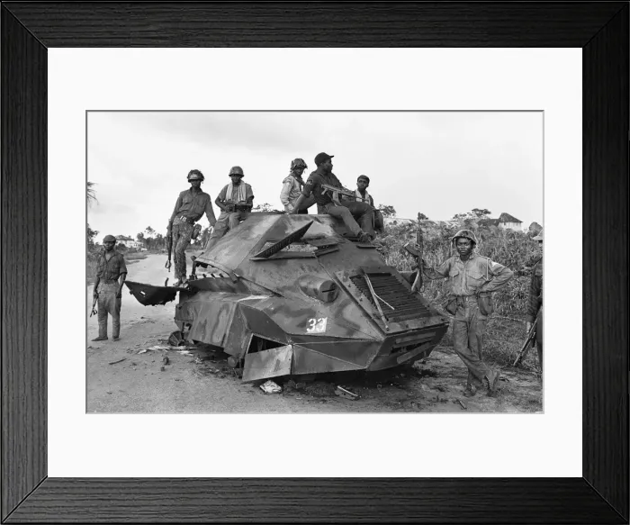 Framed Print : A Biafran soldiers seen here sitting on a destroyed Nigerian army armoured personnel Framed Print : A Biafran soldiers seen here sitting on a destroyed Nigerian army armoured personnel
