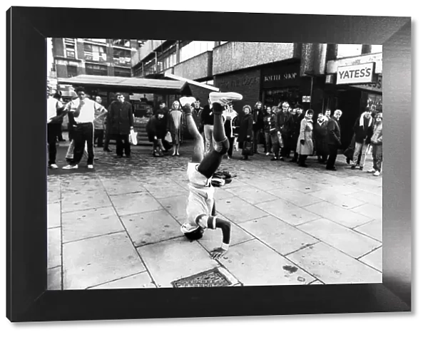 A crowd of shoppers watching a man breakdancing, Manchester. 6th February 1984