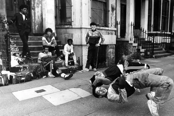 A group of breakdancers, the Eastwood Rockers, going through their break dancing paces