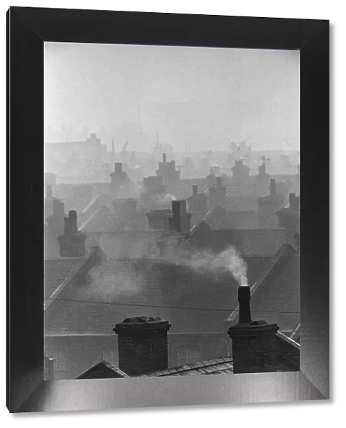 Smog caused by coal fires hangs over the roof tops of Battersea, London