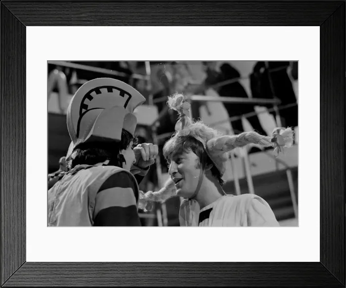 Framed Print : John Lennon from The Beatles rehearsing for the filming of