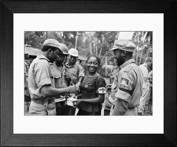 Framed Print : Biafran soldiers seen here enjoying some food held by an aid worker during the Biafran