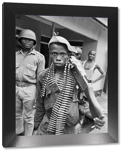 A young Biafran soldier seen here posing with a heavy machine gun