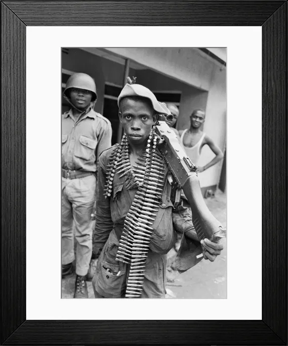 Framed Print : A young Biafran soldier seen here posing with a heavy machine gun