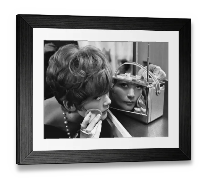 Framed Print : A young lady uses a chrome encased radio at the 1961 National Radio Show to touch up her
