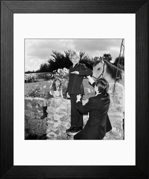 Framed Print : Child film star Mark Lester, 10 years old, being fitted for the suit which he will wear Framed Print : Child film star Mark Lester, 10 years old, being fitted for the suit which he will wear