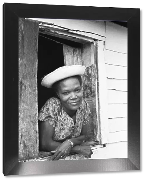 A young Maroon woman poses for the camera in her home in St Elizabeth