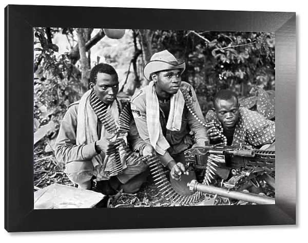 Three Biafran soldiers seen here operating a heavy machine gun during the Biafran conlict