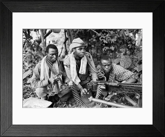 Framed Print : Three Biafran soldiers seen here operating a heavy machine gun during the Biafran conlict Framed Print : Three Biafran soldiers seen here operating a heavy machine gun during the Biafran conlict