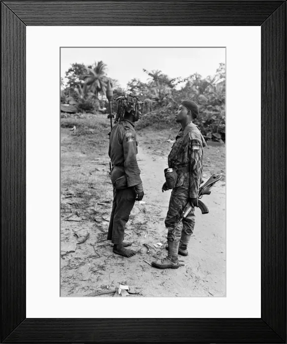 Framed Print : Two heavily armed Biafran soldiers seen here talking to each other during the Biafran Framed Print : Two heavily armed Biafran soldiers seen here talking to each other during the Biafran