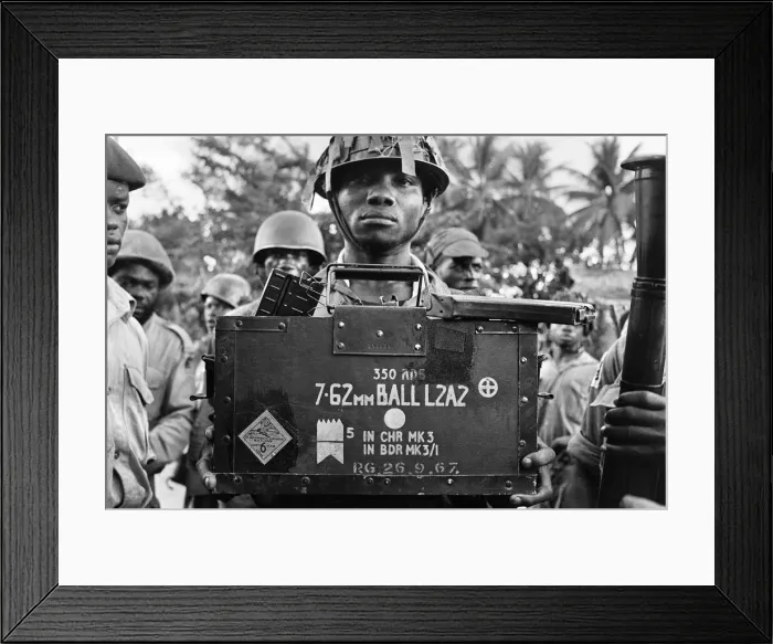 Framed Print : A Biafran soldier seen here holding a box of explosives during the Biafran conflict Framed Print : A Biafran soldier seen here holding a box of explosives during the Biafran conflict