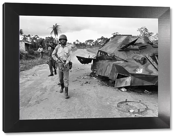 A Biafran soldier seen here beside a destroyed Nigerian army armoured personnel carrier