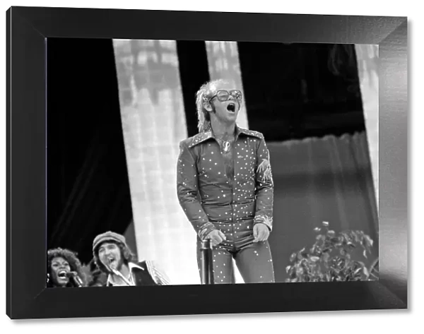 Elton John performing on stage at Wembley Stadium. London