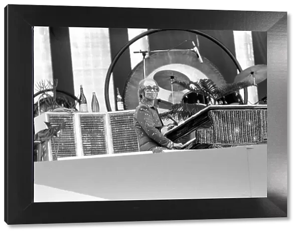 Elton John performing on stage at Wembley Stadium. London