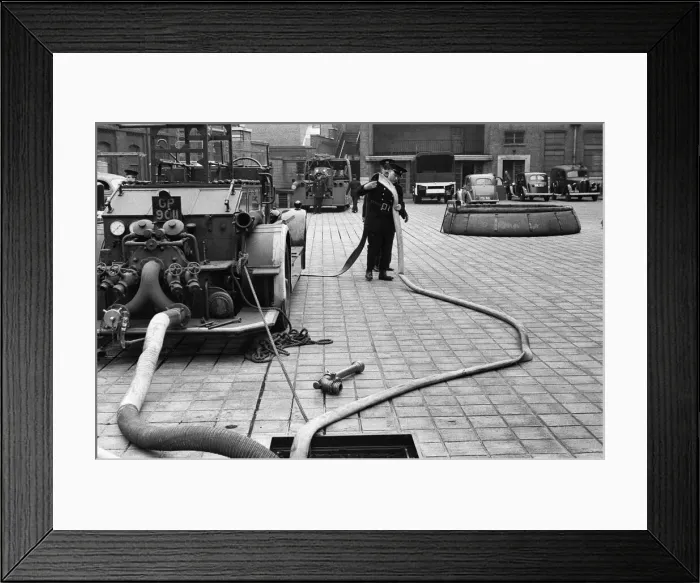 Framed Print : George Greenwell carrying hose with Station Officer Harding seen here during pump