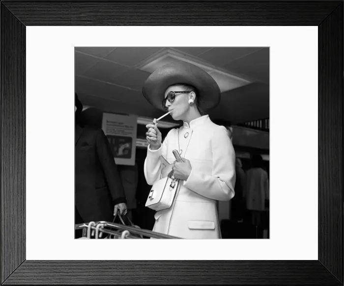 Framed Print : Leaving Heathrow Airport for Corfu is actress Joan Collins