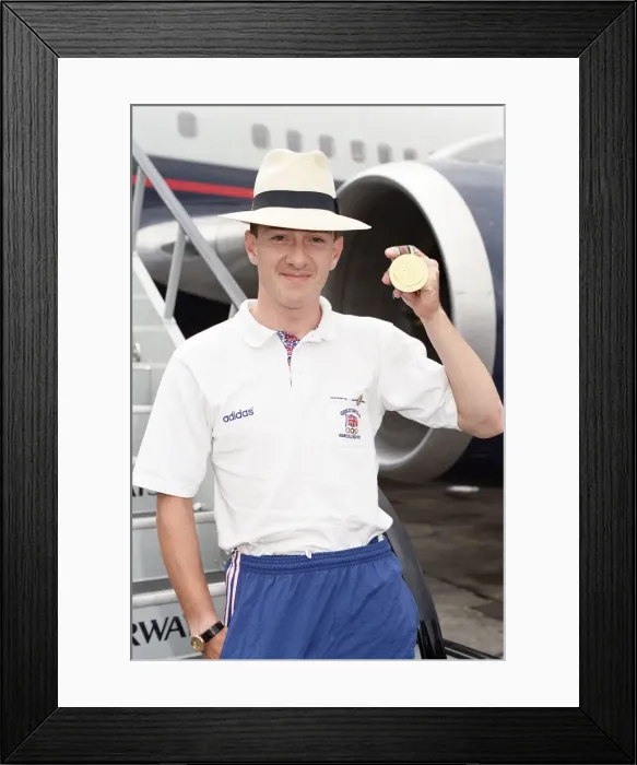 Framed Print : British cyclist Chris Boardman poses on arrival at Heathrow Airport as he returns home Framed Print : British cyclist Chris Boardman poses on arrival at Heathrow Airport as he returns home