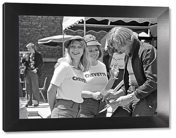 Motor Racing Driver James Hunt signs his autograph for two of his female stewardesses at