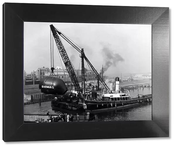 Bessemer steel plant, for Margam works. Crane hoists it clear of the ship. July 1958