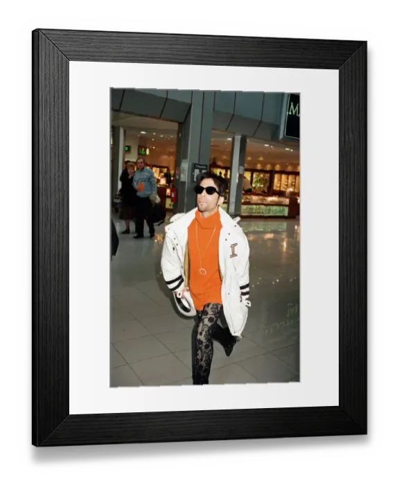 Framed Print : American pop star, the artist formerly known as Prince, leaving Heathrow Airport for New