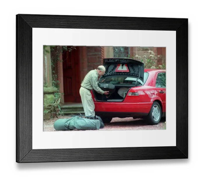 Framed Print : Fergus McCann packs his belongings into the boot of his Mercedes April 1999 as he