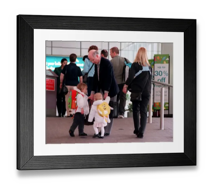 Framed Print : Fergus McCann and family at Glasgow Airport April 1999 taking hold of his