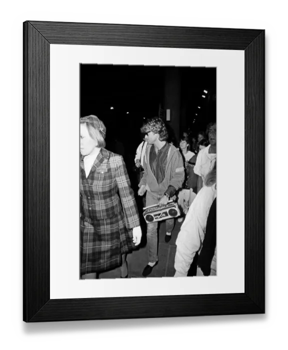 Framed Print : George Michael of the pop group Wham!, arriving at Gatwick airport on his return Framed Print : George Michael of the pop group Wham!, arriving at Gatwick airport on his return