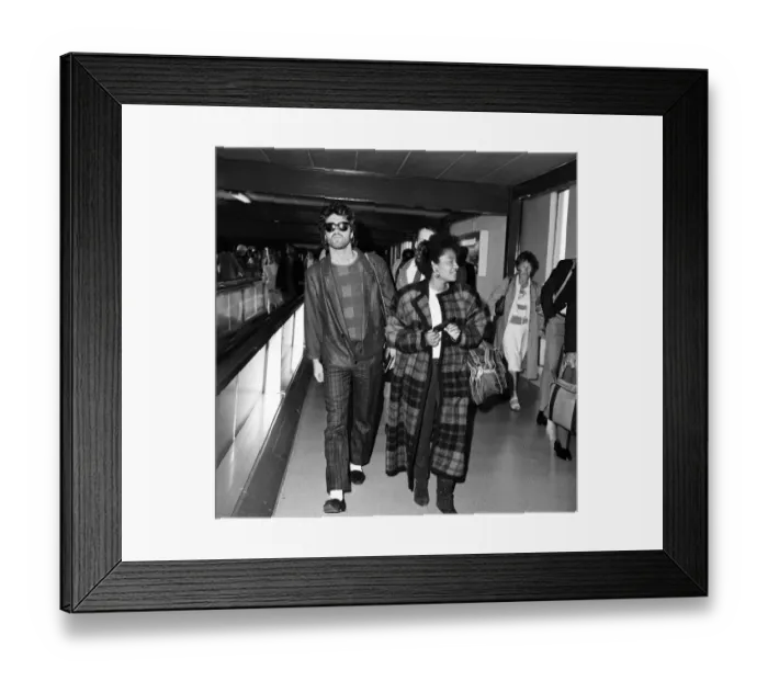 Framed Print : George Michael of the pop group Wham!, and girlfriend Pat Fernandez at London airport
