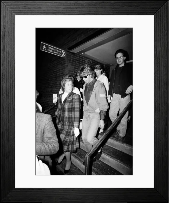 Framed Print : George Michael of the pop group Wham!, arriving at Gatwick airport on his return Framed Print : George Michael of the pop group Wham!, arriving at Gatwick airport on his return