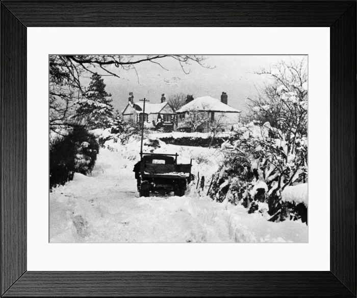 Framed Print : A vehicle making its way through thick snow in rural Llanedeyrn