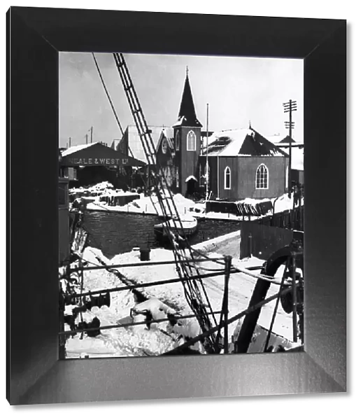 A corner of the Cardiff docks showing the Norwegian church covered in snow after a heavy