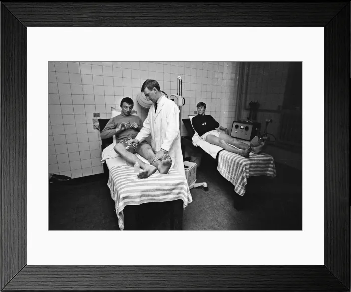 Framed Print : Mike Summerbee (left) being examined Manchester City players Colin Bell Framed Print : Mike Summerbee (left) being examined Manchester City players Colin Bell