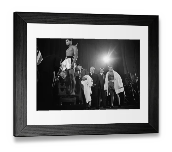 Framed Print : Muhammad Ali stands on the scales as Brian London looks on at the weigh-in ahead of their