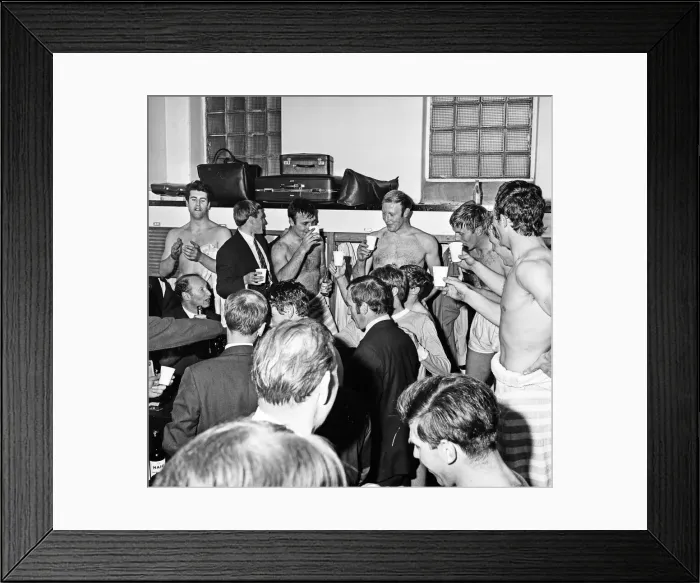 Framed Print : Manchester City players celebrate with champagne in the dressing room after sealing Framed Print : Manchester City players celebrate with champagne in the dressing room after sealing