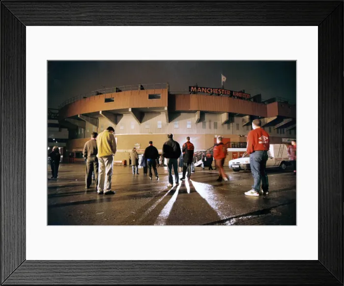 Framed Print : Manchester United fans bow their heads in respect during a slient vigil outside Old