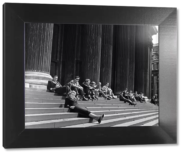 Lunch hour sunbathers sit on the steps of St Pauls Cathedral, London. 1st June 1954