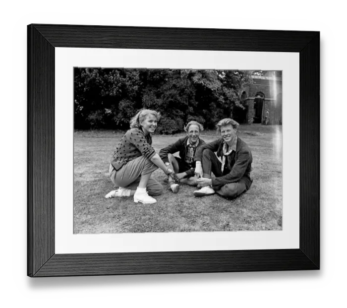 Framed Print : Youth Club. Three teenage friends enjoy sitting outdoors in the summer