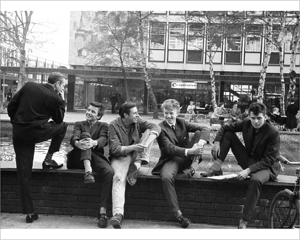 Young lads gather around the fountain in Stevenage Town Centre, Hertfordshire