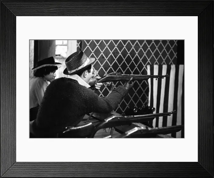 Framed Print : Holidaymaker tries his luck on the rifle range at the end of Southend pier Framed Print : Holidaymaker tries his luck on the rifle range at the end of Southend pier