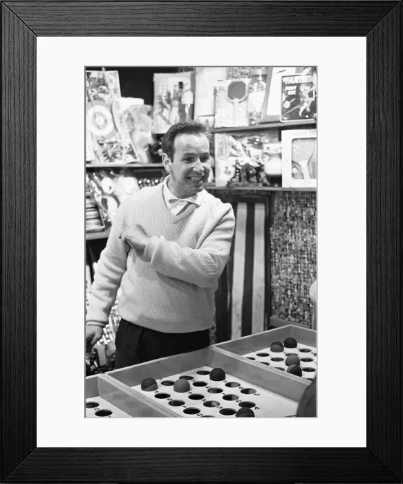 Framed Print : A side stall operator at the end of Southend pier, having a good day as the rainy weather